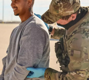 Federalni agent pretresa migranta pre ukrcavanja u avion